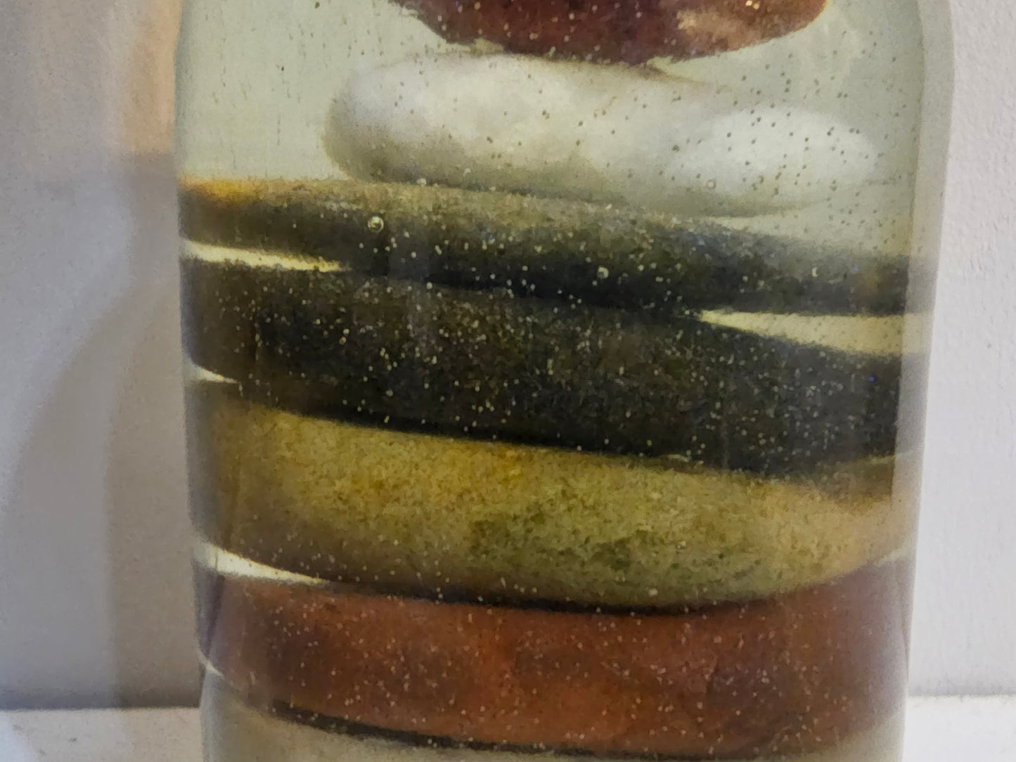 Stacked beach stones in a bottle or bag