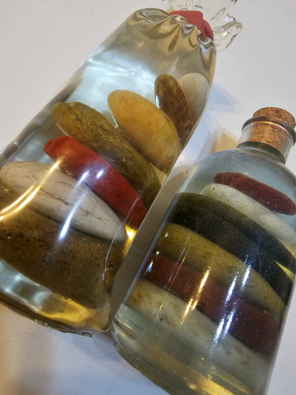 Stacked beach stones in a bottle or bag