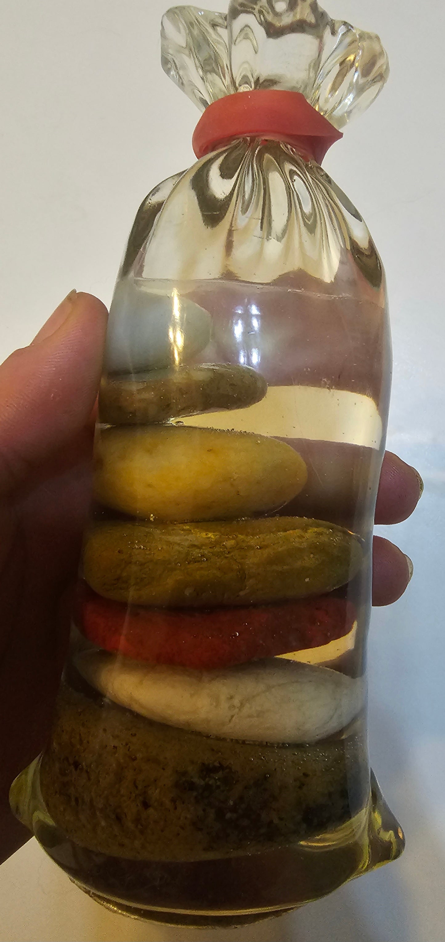 Stacked beach stones in a bottle or bag