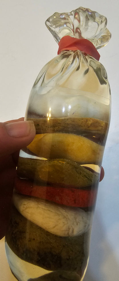 Stacked beach stones in a bottle or bag