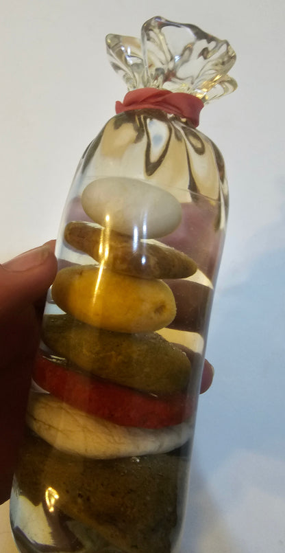 Stacked beach stones in a bottle or bag