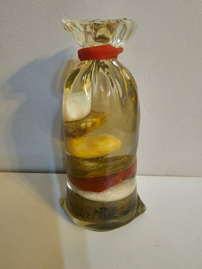 Stacked beach stones in a bottle or bag