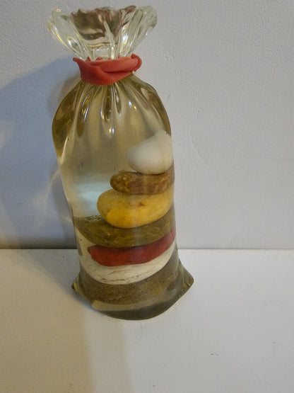 Stacked beach stones in a bottle or bag