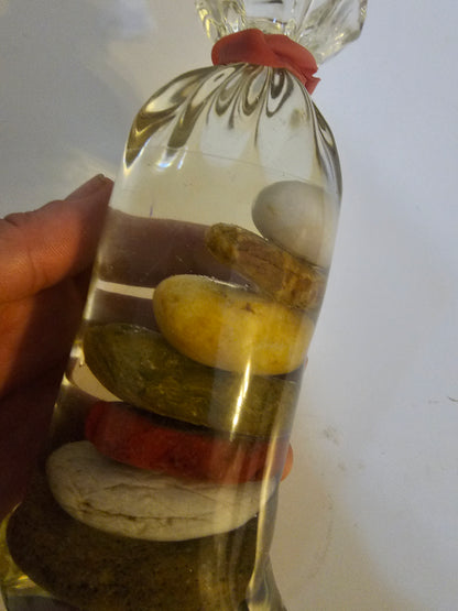 Stacked beach stones in a bottle or bag