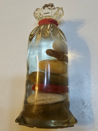 Stacked beach stones in a bottle or bag