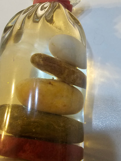 Stacked beach stones in a bottle or bag