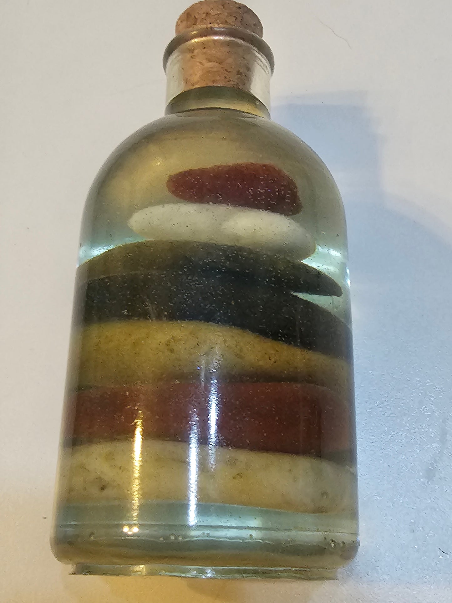 Stacked beach stones in a bottle or bag