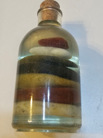 Stacked beach stones in a bottle or bag