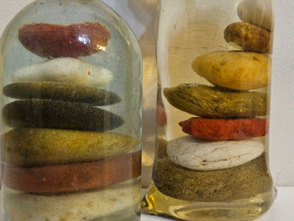 Stacked beach stones in a bottle or bag