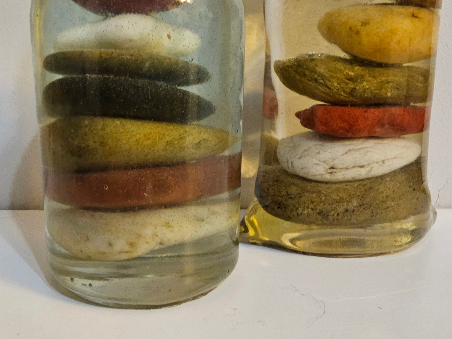 Stacked beach stones in a bottle or bag